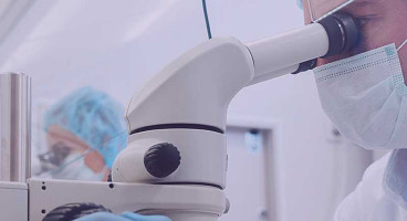 hero markets scientist looking into microscope